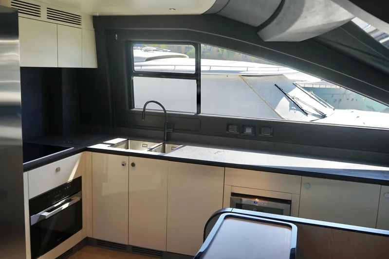  Yacht Photos Pics Modern kitchen interior of 2023 Azimut Fly 78 yacht with sleek design and appliances.