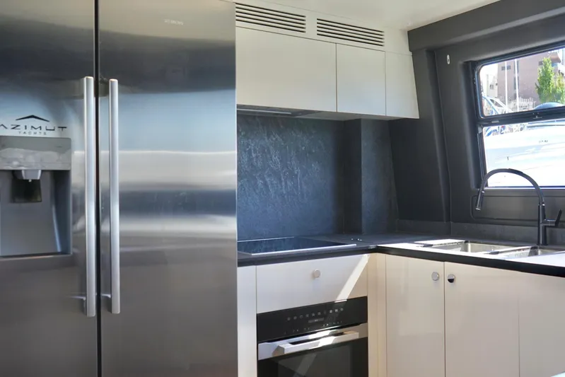  Yacht Photos Pics Modern kitchen interior of 2023 Azimut Fly 78 yacht with sleek appliances.