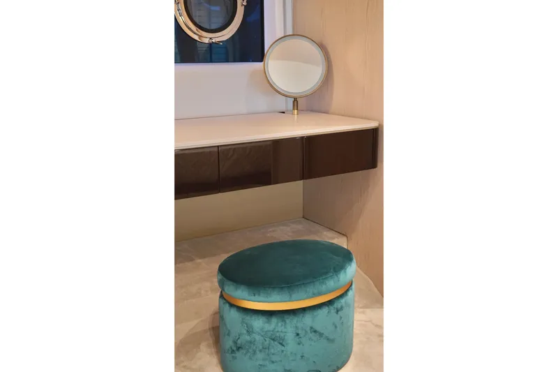  Yacht Photos Pics Elegant vanity area on 2023 Azimut Fly 78 yacht with teal stool and round mirror.