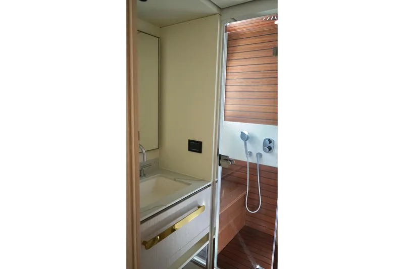  Yacht Photos Pics Luxurious bathroom in 2023 Azimut Fly 78 yacht with modern fixtures and wooden accents.