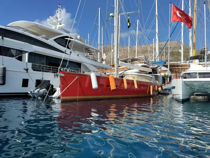 Felitsata II Yacht Photos Pics Red Moody 62 DS yacht docked in marina, Turkish flag visible, clear blue sky.
