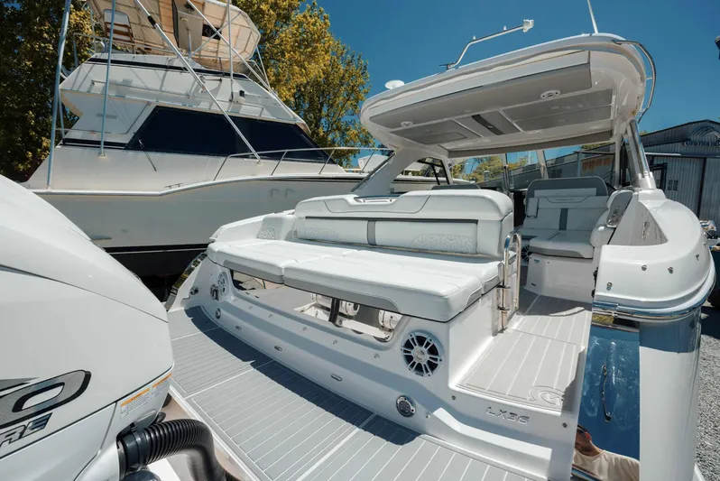  Yacht Photos Pics 2022 Regal LX36 luxury boat with spacious seating and sleek design in a marina setting.