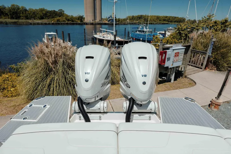  Yacht Photos Pics 2022 Regal LX36 boat with dual V8 engines docked by a scenic waterfront.