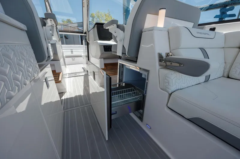  Yacht Photos Pics 2022 Regal LX36 boat interior with luxurious seating and open storage compartments.
