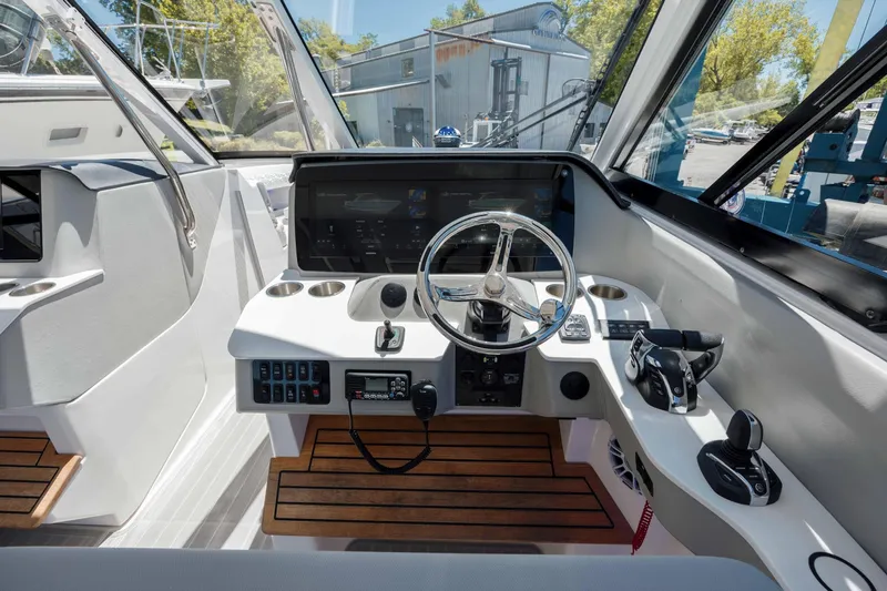  Yacht Photos Pics 2022 Regal LX36 boat cockpit with modern controls and wooden flooring.