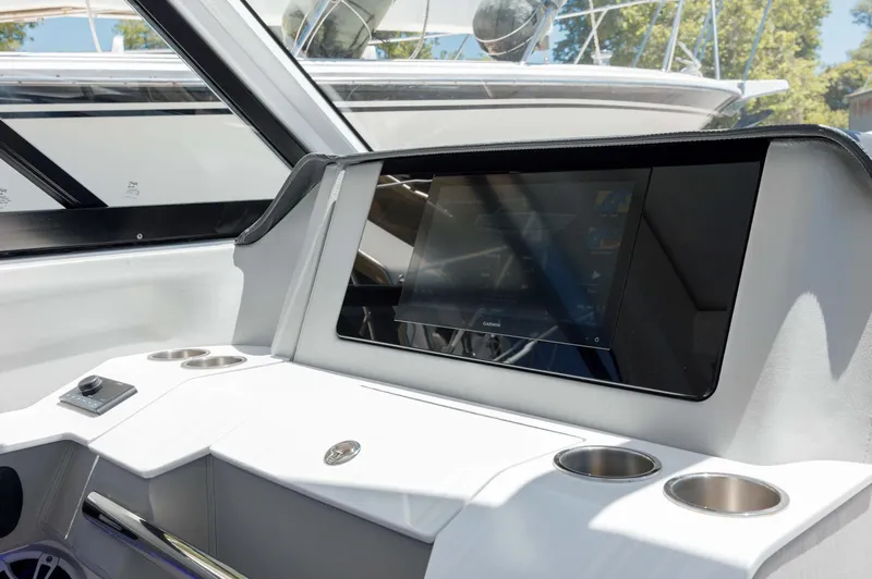  Yacht Photos Pics Interior of 2022 Regal LX36 boat with modern dashboard and touchscreen display.