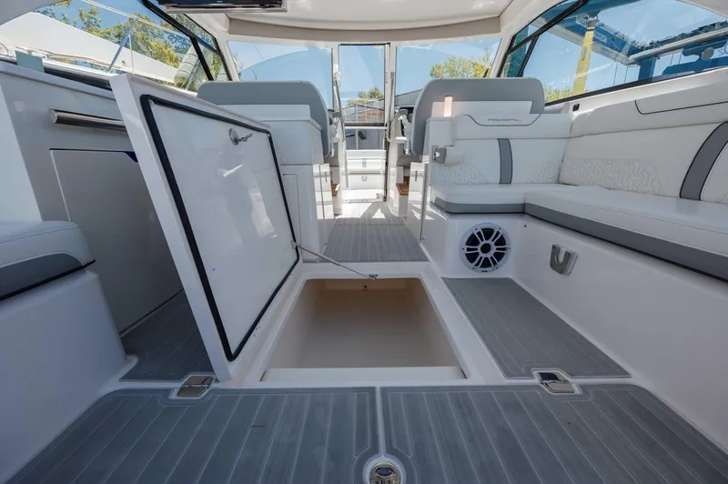  Yacht Photos Pics 2022 Regal LX36 boat interior with open storage compartment and seating area.