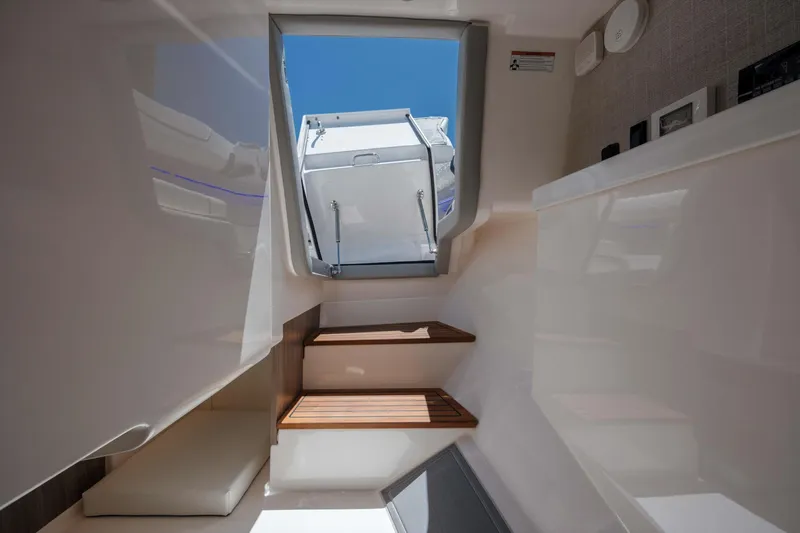  Yacht Photos Pics Interior view of 2022 Regal LX36 yacht with wooden steps and open hatch.