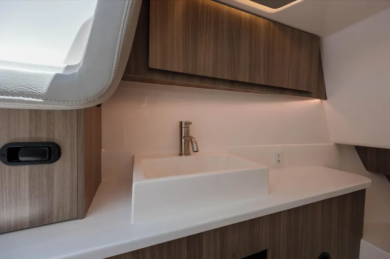  Yacht Photos Pics Modern bathroom interior of 2022 Regal LX36 boat with sleek sink and wood cabinetry.
