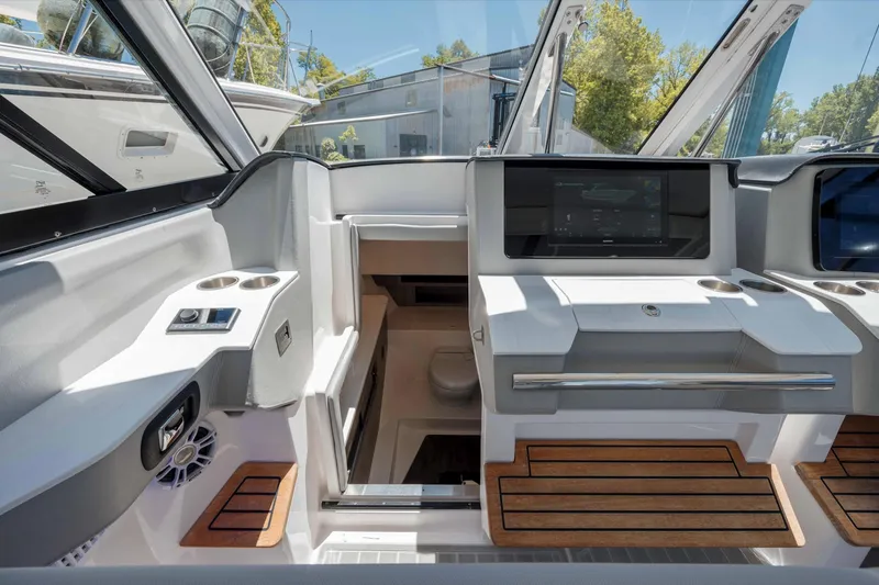  Yacht Photos Pics 2022 Regal LX36 boat interior with modern dashboard and wooden accents.
