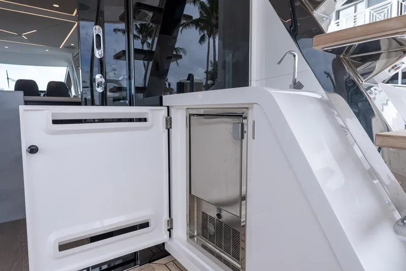  Yacht Photos Pics 2024 Sunseeker Manhattan 68 yacht interior with open storage and sink.