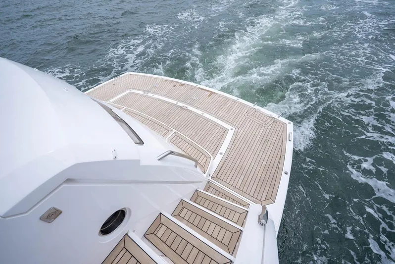  Yacht Photos Pics 2024 Sunseeker Manhattan 68 yacht stern with teak deck on open water.