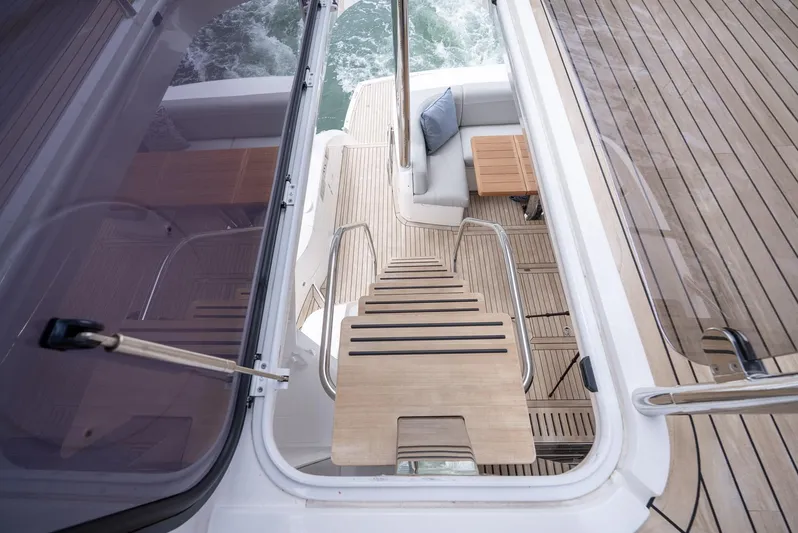  Yacht Photos Pics 2024 Sunseeker Manhattan 68 yacht deck with elegant seating and wooden flooring.