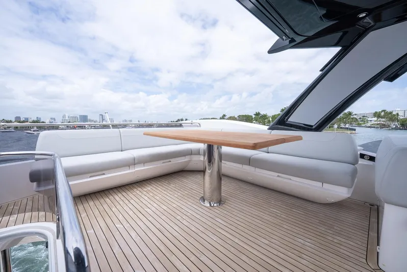  Yacht Photos Pics 2024 Sunseeker Manhattan 68 yacht deck with sleek seating and wooden table.