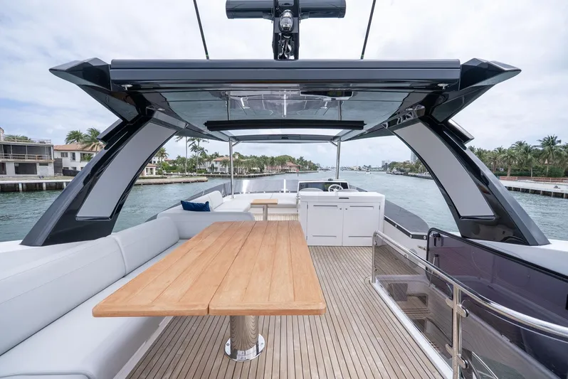  Yacht Photos Pics 2024 Sunseeker Manhattan 68 yacht deck with modern seating and wooden table.