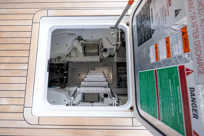  Yacht Photos Pics Engine compartment of 2024 Sunseeker Manhattan 68 yacht, featuring access hatch and safety warnings.
