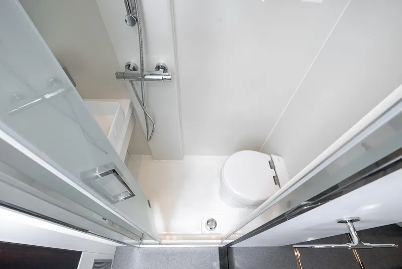  Yacht Photos Pics Bathroom interior of 2024 Sunseeker Manhattan 68 yacht, featuring modern shower and toilet.