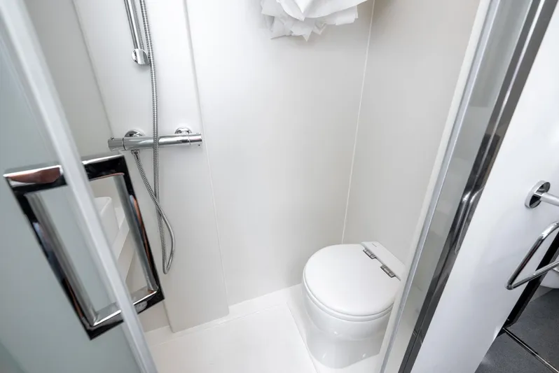  Yacht Photos Pics Luxurious bathroom in 2024 Sunseeker Manhattan 68 yacht, featuring modern shower and toilet.