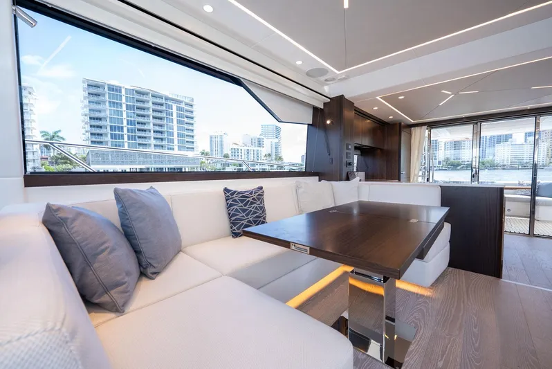  Yacht Photos Pics Luxurious interior of 2024 Sunseeker Manhattan 68 yacht with modern seating and city view.