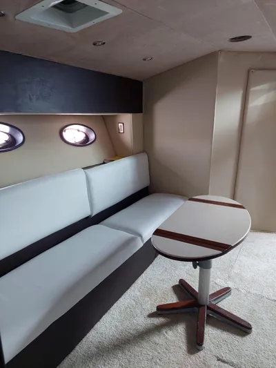 Loki Yacht Photos Pics Interior of 1998 Sea Ray 450 Sundancer with sofa and table.