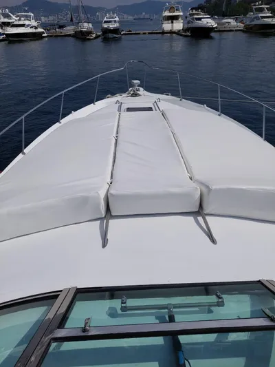 Loki Yacht Photos Pics 1998 Sea Ray 450 Sundancer yacht docked at a marina.