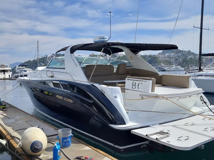 Loki Yacht Photos Pics 1998 Sea Ray 450 Sundancer yacht docked at marina.