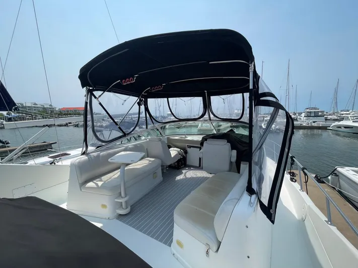 Andiamo Freedom Yacht Photos Pics 2006 Carver 36 Mariner yacht interior with seating and canopy in marina setting.