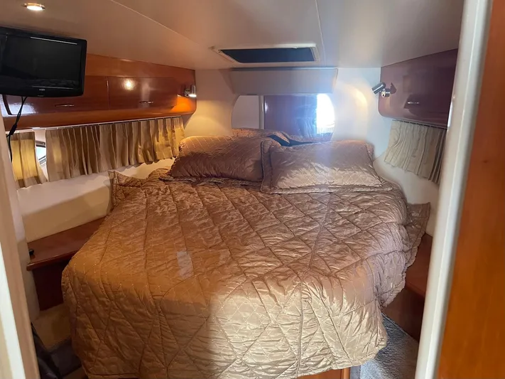 Andiamo Freedom Yacht Photos Pics Luxurious cabin interior of 2006 Carver 36 Mariner with cozy bedding and wood accents.