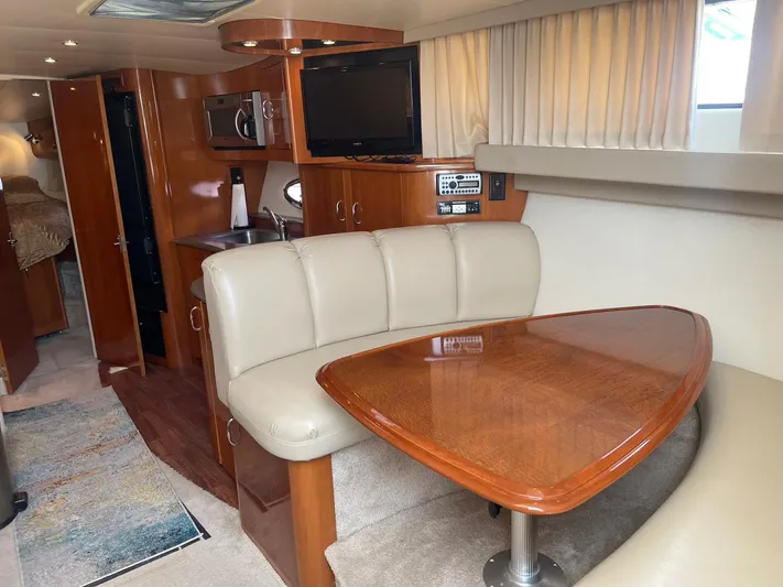 Andiamo Freedom Yacht Photos Pics 2006 Carver 36 Mariner interior with dining area, TV, and kitchenette.