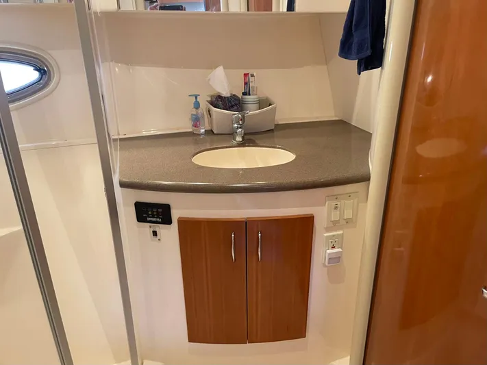 Andiamo Freedom Yacht Photos Pics Bathroom vanity in a 2006 Carver 36 Mariner yacht, featuring a sink and storage cabinet.