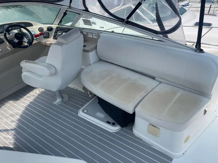 Andiamo Freedom Yacht Photos Pics 2006 Carver 36 Mariner interior with helm, seating, and striped flooring.