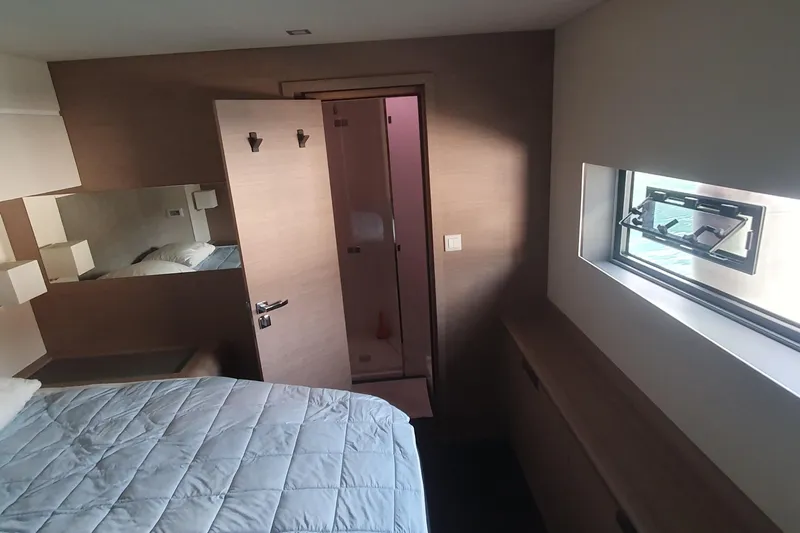  Yacht Photos Pics Luxurious cabin interior of 2023 Fountaine Pajot Samana 59 yacht, featuring modern design and window view.