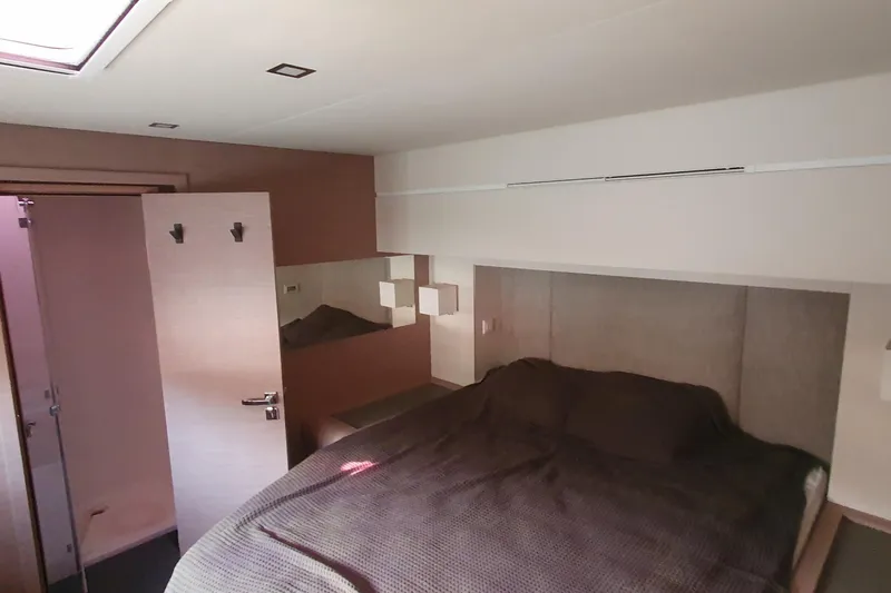  Yacht Photos Pics Luxurious bedroom interior of 2023 Fountaine Pajot Samana 59 yacht with modern design.