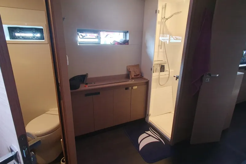  Yacht Photos Pics Bathroom interior of 2023 Fountaine Pajot Samana 59 yacht, featuring shower and toilet.