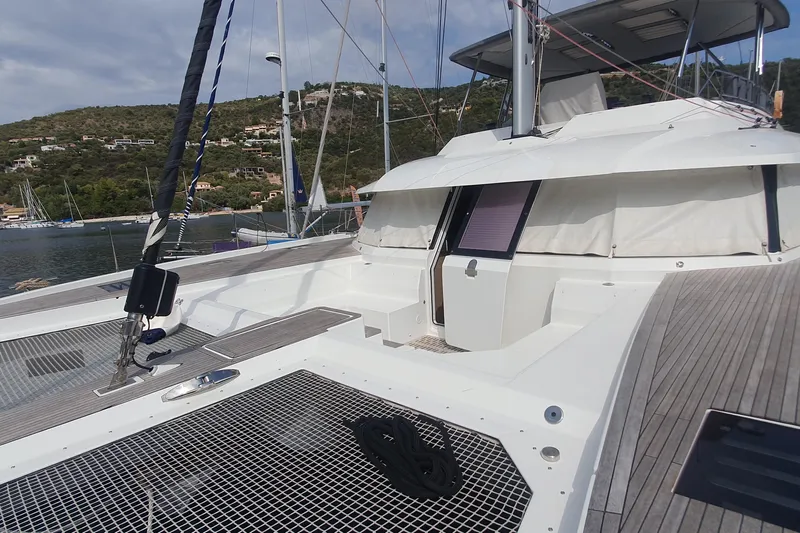  Yacht Photos Pics 2023 Fountaine Pajot Samana 59 yacht deck with scenic coastal backdrop.