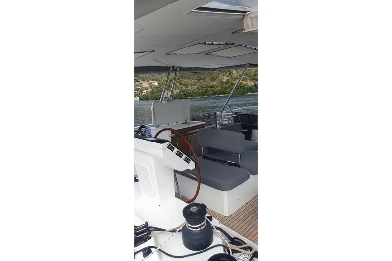  Yacht Photos Pics 2023 Fountaine Pajot Samana 59 yacht interior with seating and steering wheel.