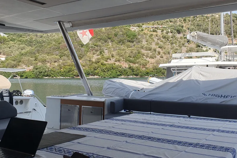  Yacht Photos Pics 2023 Fountaine Pajot Samana 59 yacht interior with scenic water and hillside view.
