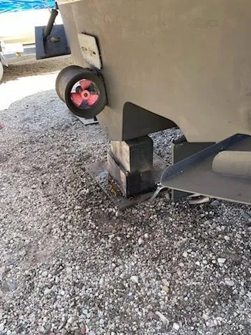  Yacht Photos Pics Rear view of a 2004 Sea Ray 360 Sundancer boat propped on gravel.