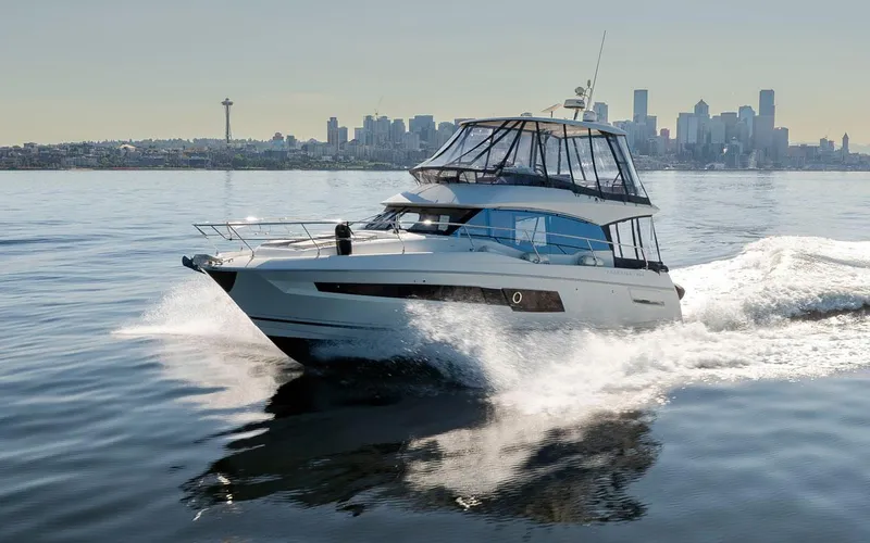 Four At Sea Yacht Photos Pics 2019 Prestige 460 yacht cruising with city skyline in the background.