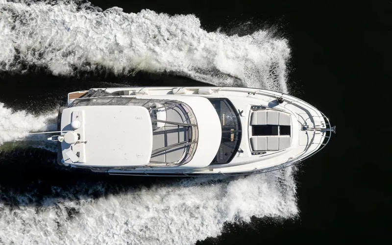 Four At Sea Yacht Photos Pics Overhead view of a 2019 Prestige 460 yacht cruising on water.