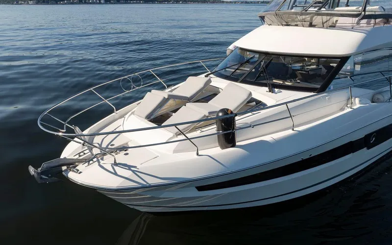 Four At Sea Yacht Photos Pics 2019 Prestige 460 yacht on calm water, featuring sleek design and sunbathing area.