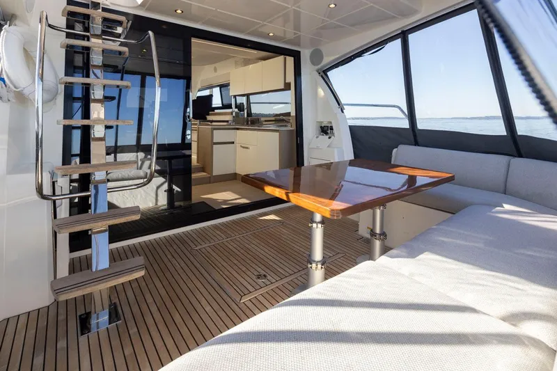 Four At Sea Yacht Photos Pics Luxurious interior of 2019 Prestige 460 yacht with modern kitchen and seating area.