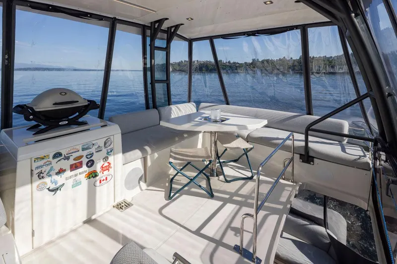 Four At Sea Yacht Photos Pics Luxurious 2019 Prestige 460 yacht interior with seating, table, and grill, overlooking serene waters.