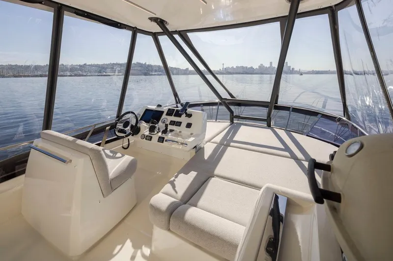 Four At Sea Yacht Photos Pics Interior view of 2019 Prestige 460 yacht helm with panoramic windows and city skyline.