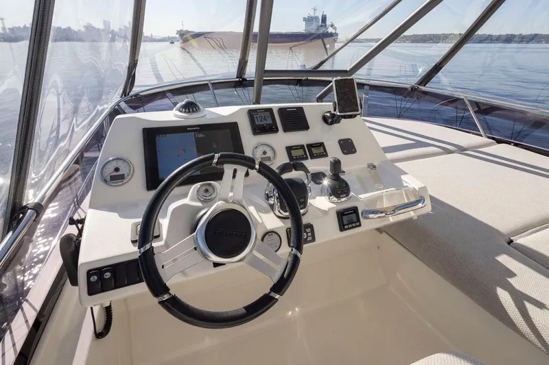 Four At Sea Yacht Photos Pics Cockpit of 2019 Prestige 460 yacht with steering wheel and navigation controls.