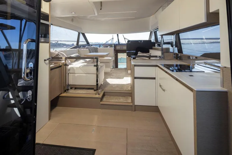 Four At Sea Yacht Photos Pics Luxurious interior of a 2019 Prestige 460 yacht with modern kitchen and seating area.