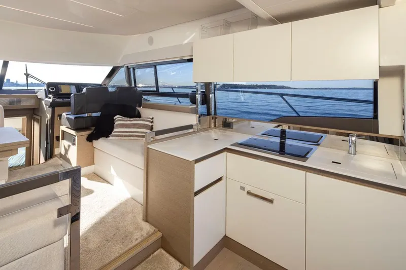 Four At Sea Yacht Photos Pics Luxurious interior of 2019 Prestige 460 yacht with modern kitchen and helm station.