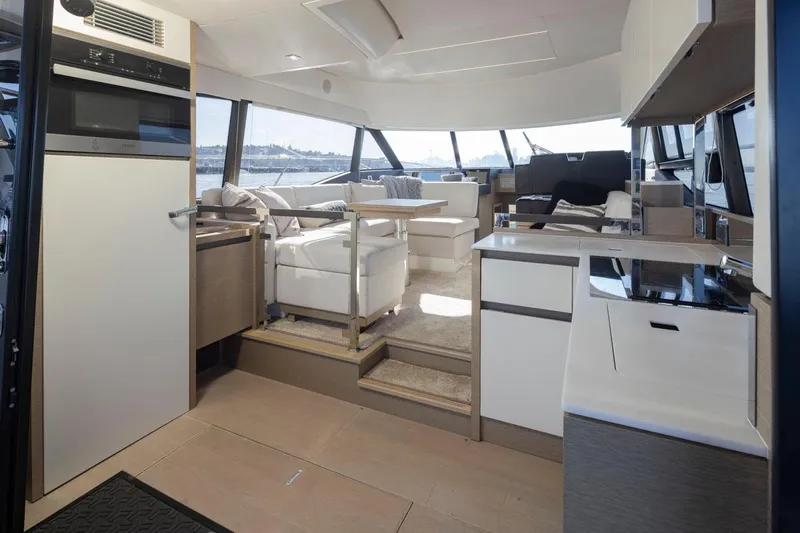 Four At Sea Yacht Photos Pics Luxurious interior of 2019 Prestige 460 yacht with modern kitchen and seating area.