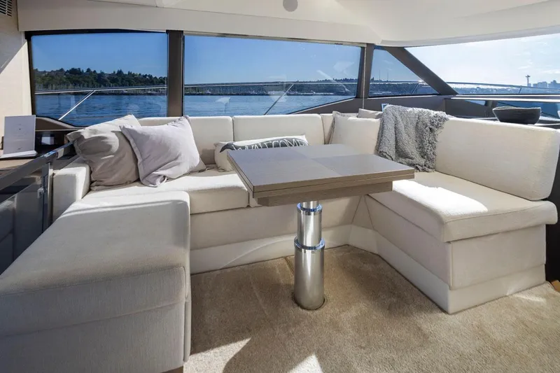 Four At Sea Yacht Photos Pics Luxurious interior of 2019 Prestige 460 yacht with plush seating and scenic water views.