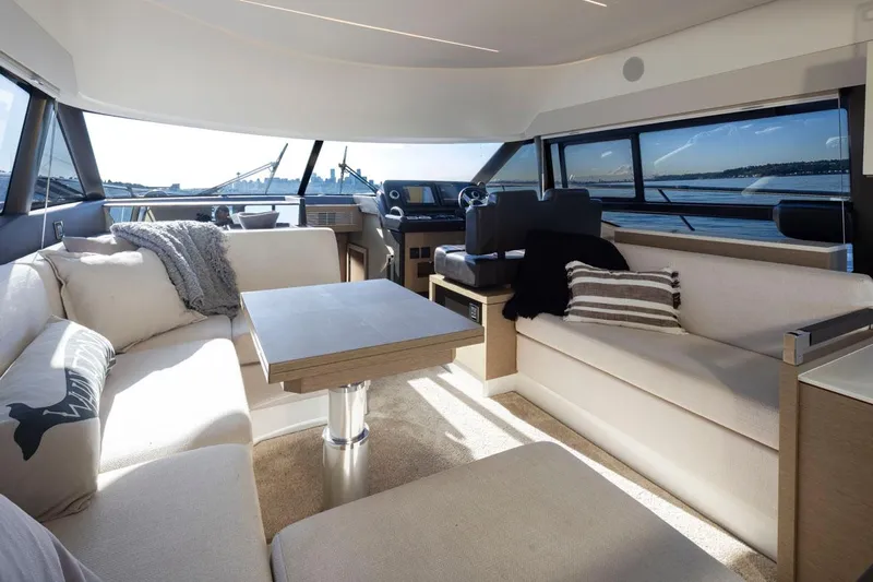 Four At Sea Yacht Photos Pics Luxurious interior of 2019 Prestige 460 yacht with elegant seating and panoramic windows.